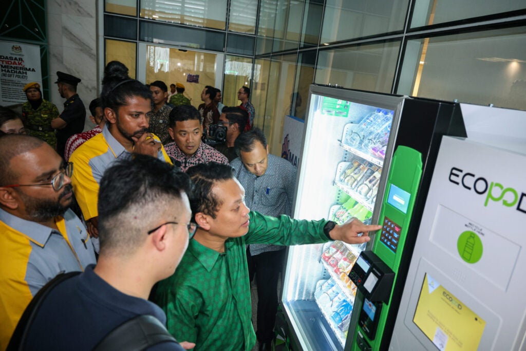 Minister of Natural Resources and Environmental Sustainability of Malaysia Nik Nazmi bin Nik Ahmad testing out the ATLAS ECOPODs redemption feature on an ATLAS Vending Machine.