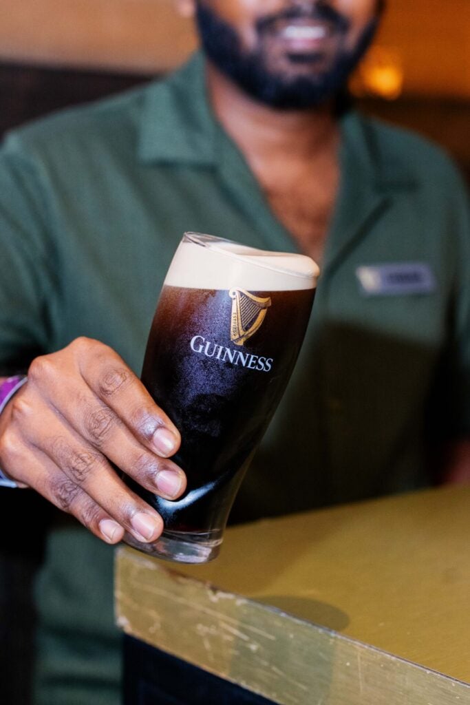 Chief Pint Officer CPO finalist Thibaan Anadcaan successfully passing the Tilt Test after pouring his perfect pint of Guinness Draught as part of the live pouring challenge