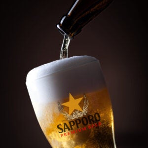 Sapporo beer pouring bottle closed up 2