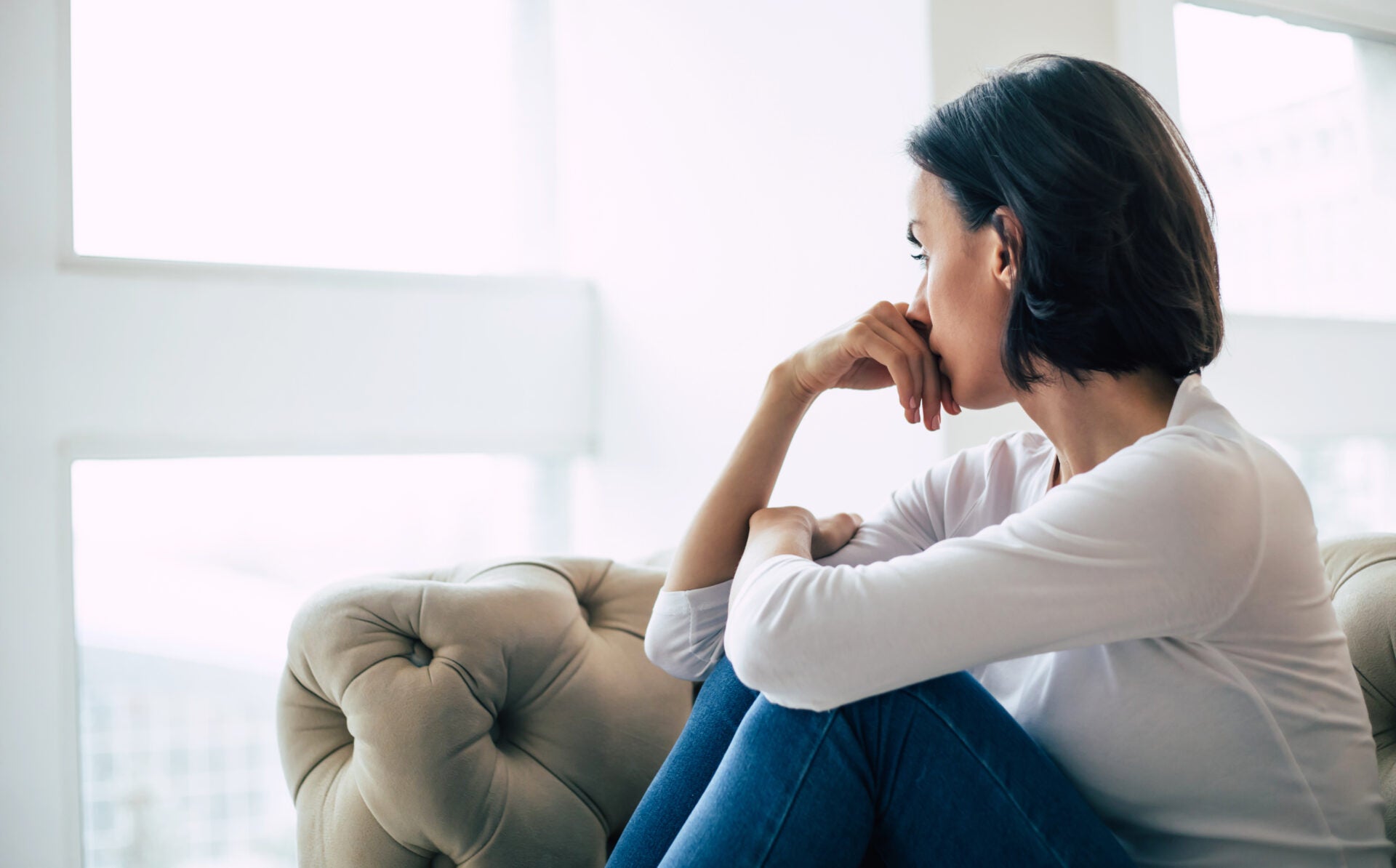 depressed woman with short haircut who is crying while touching her face girl who is yelling with her eyes closed because her mental illness