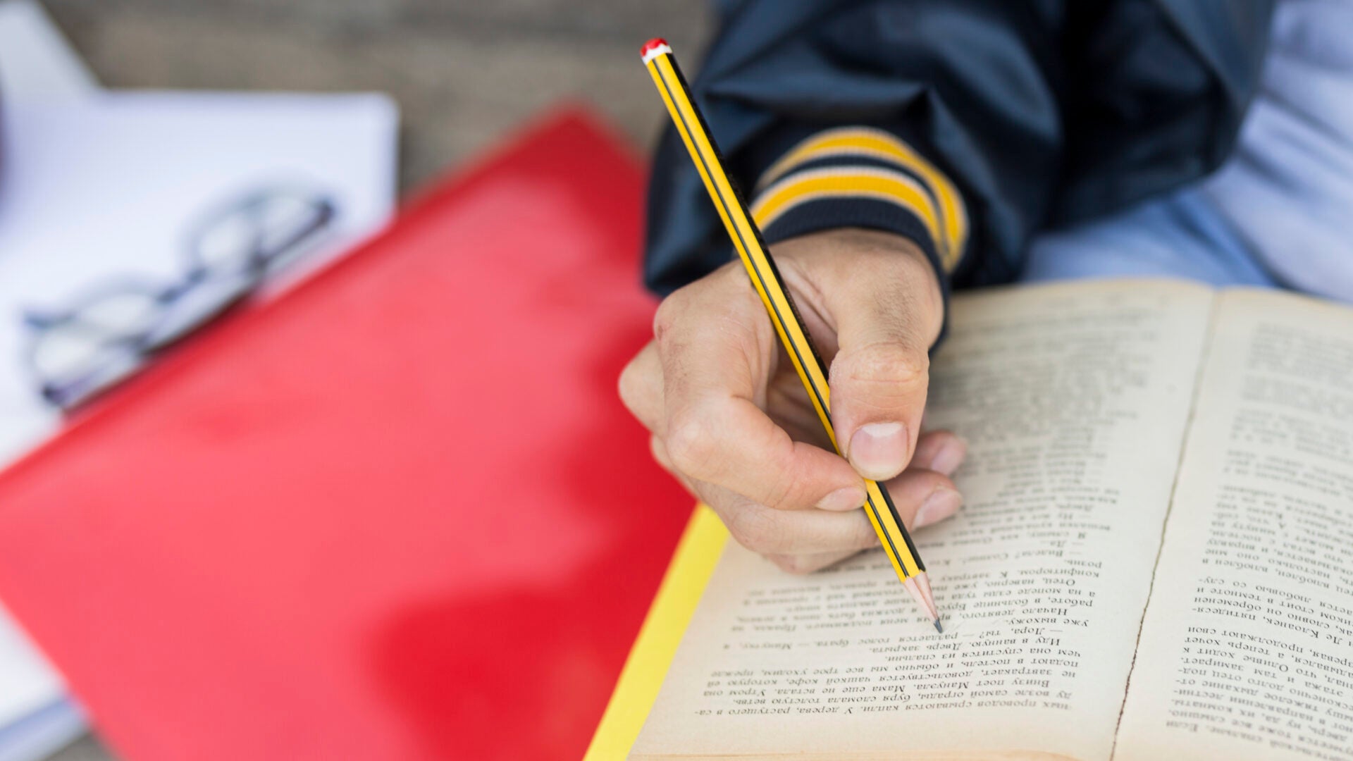 young man pricking down book