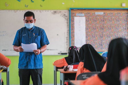 162474807 muadzam shah malaysia january 20th 2021 teacher and student with face mask back at school