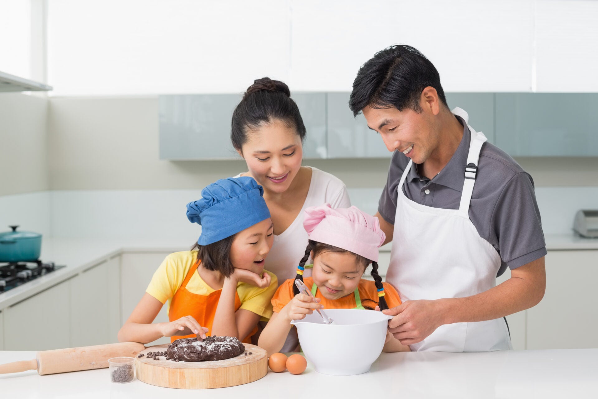 happy family four preparing cookies kitchen