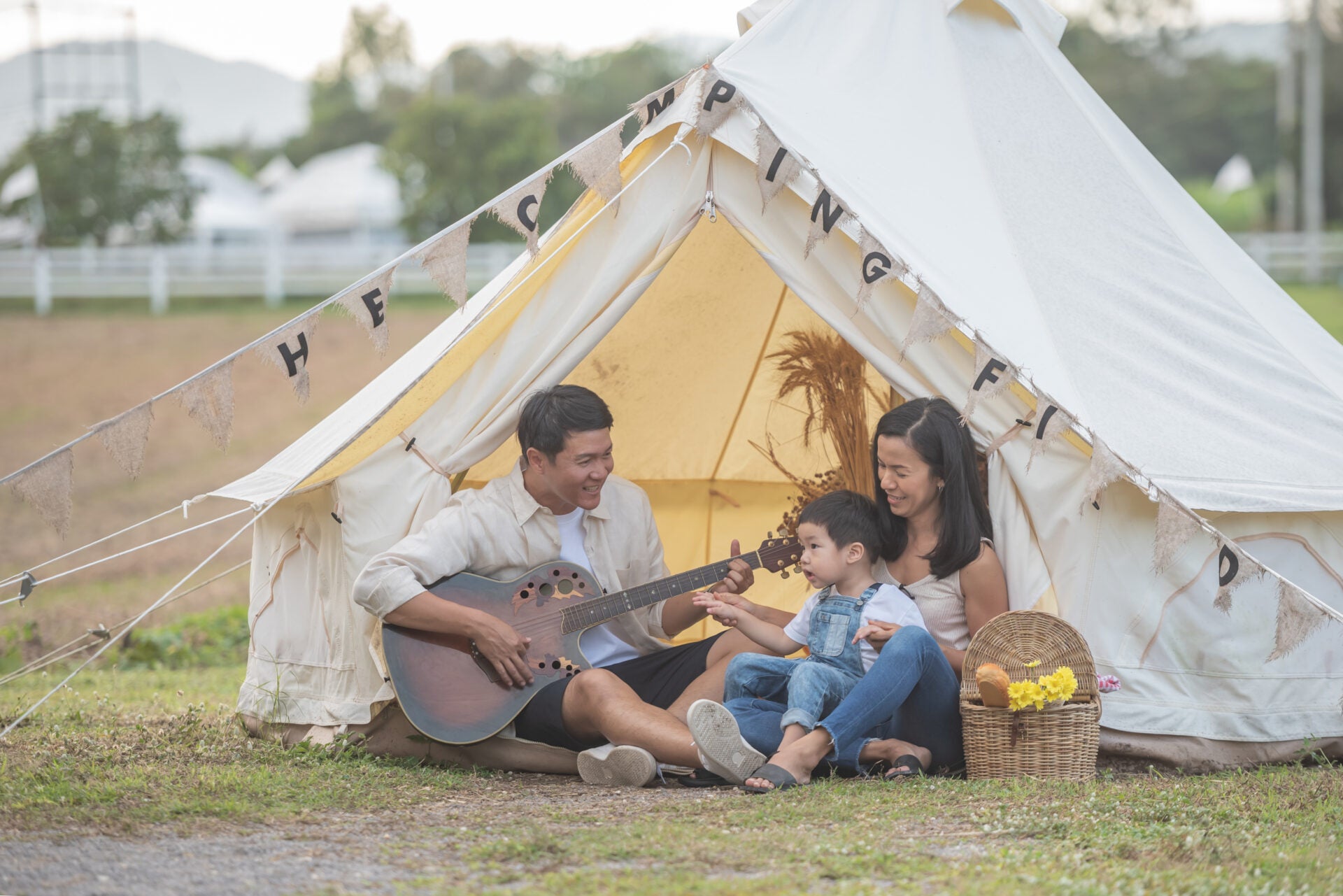 child singing with smiling family camping family enjoying camping holiday countryside